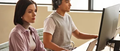 A man and woman working at a desk