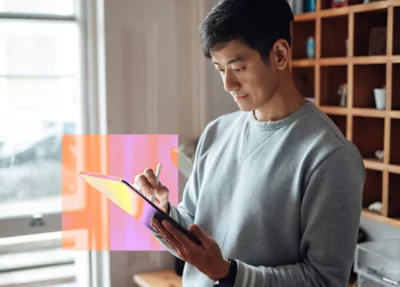 A person typing on a laptop with a screen displaying cyber threat protection resources.