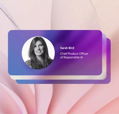 Profilkarte mit einem Graustufenporträt einer Frau und dem Text: „Sarah Bird, Chief Product Officer of Responsible AI“ auf einem lila-weißen Farbverlaufshintergrund.