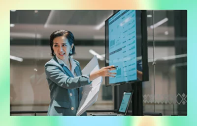 A women showing something into a big screen.