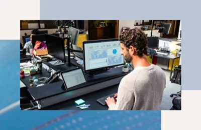 A person sitting at a desk looking at a computer screen.