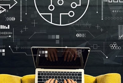 Hands typing on a laptop keyboard with abstract white line drawings in the background.