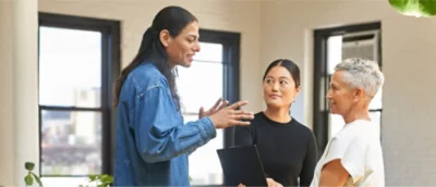 Three persons talking with each other