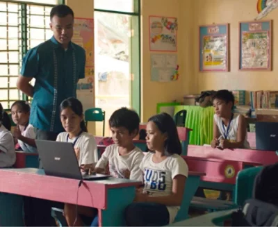 A group of children sitting at desks in a classroom.