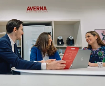 A group of people sitting at a table with laptops.