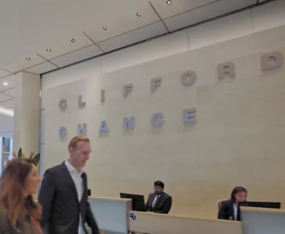 A group of people in front of a wall with partially visible text FOR ANCE.