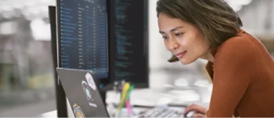 A woman sitting at a desk using a computer.