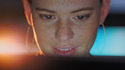 A woman looking at the laptop screen