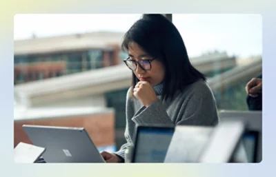 Person using a laptop in a bright, modern workspace.