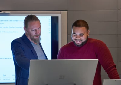 Two men looking at computer screen