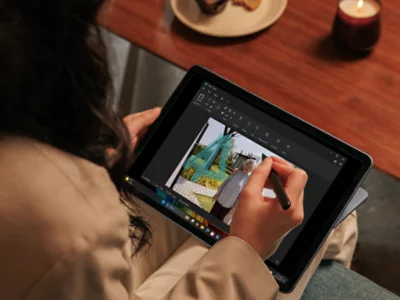 Person using a Slim Pen to edit a photo on a Surface Pro, showcasing precision and creativity. 