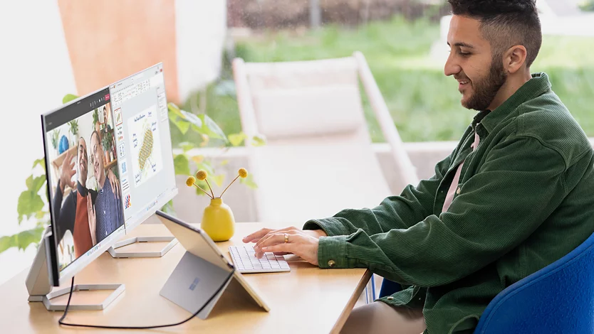 Contextual photography of adult male using Surface Pro 9.