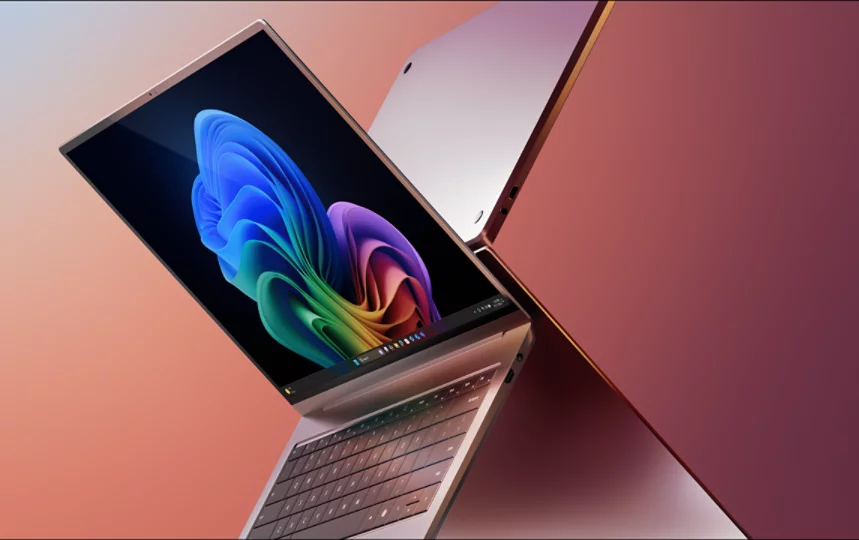 Två öppna bärbara datorer som visar en regnbågsblomma på en av skärmarna