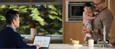 A person sitting at a table with a computer