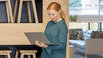 A woman using a laptop in a small business
