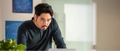 A man is working on a laptop.