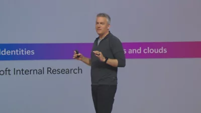 A man standing and giving presentation.